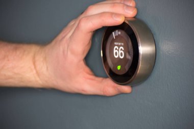 Green tech- Electric thermostat to save money and energy clipart