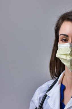 Gri bir arka planda kadın hemşire portresi. Metin, alıntı ve kopya için izole edilmiş.