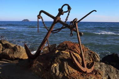 Alassio (SV), Italy - February 15, 2017: An old anchor at Alassio beach, Riviera dei Fiori, Savona, Liguria, Italy.