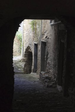 Triora (IM), Italy - February 15, 2017: A small path through the houses in the witches village of Triora, Imperia, Liguria, Italy. 