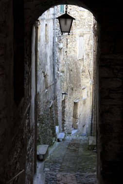 Triora (IM), Italy - February 15, 2017: A small path through the houses in the witches village of Triora, Imperia, Liguria, Italy. 