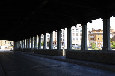 Pavia (PV), Italy - June 09, 2018: The Ponte Coperto (covered bridge), also known as the Ponte Vecchio (old bridge), a brick and stone arch bridge over the Ticino River in Pavia, Lombardy, Italy