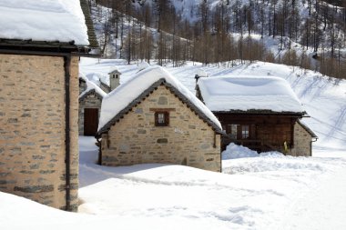 Devero Park ( Verbano-Cusio-Ossola ), Italy - January 15, 2017: Crampiolo village and houses in Alpe Devero Park, Ossola Valley, VCO, Piedmont, Italy