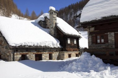 Devero Park ( Verbano-Cusio-Ossola ), Italy - January 15, 2017: Crampiolo village and houses in Alpe Devero Park, Ossola Valley, VCO, Piedmont, Italy