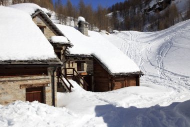 Devero Park ( Verbano-Cusio-Ossola ), Italy - January 15, 2017: Crampiolo village and houses in Alpe Devero Park, Ossola Valley, VCO, Piedmont, Italy