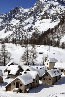 Devero Park ( Verbano-Cusio-Ossola ), Italy - January 15, 2017: Crampiolo village and houses in Alpe Devero Park, Ossola Valley, VCO, Piedmont, Italy