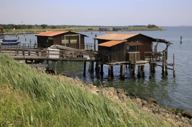 Po river (FE),  Italy - April 30, 2017: Fisherman's houses on Po river, Delta Regional Park, Emilia Romagna, Italy