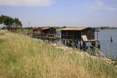 Po river (FE),  Italy - April 30, 2017: Fisherman's houses on Po river, Delta Regional Park, Emilia Romagna, Italy