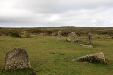 Madron (England), UK - August 16, 2015: A tourist near The famous Men an Tol a Megalithic stone and Tomb near Madron, West Penwith, Cornwall, England, United Kingdom.
