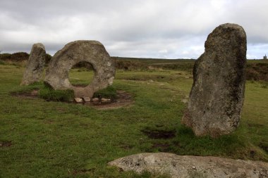 Madron (England), UK - August 16, 2015: A tourist near The famous Men an Tol a Megalithic stone and Tomb near Madron, West Penwith, Cornwall, England, United Kingdom.