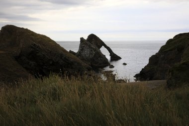 Portknockie (Scotland), UK - August 01, 2018: Bow Fiddle Rock sea arch, Portknockie, Scotland, Highlands, United Kingdom