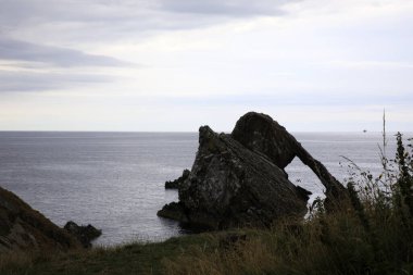 Portknockie (Scotland), UK - August 01, 2018: Bow Fiddle Rock sea arch, Portknockie, Scotland, Highlands, United Kingdom