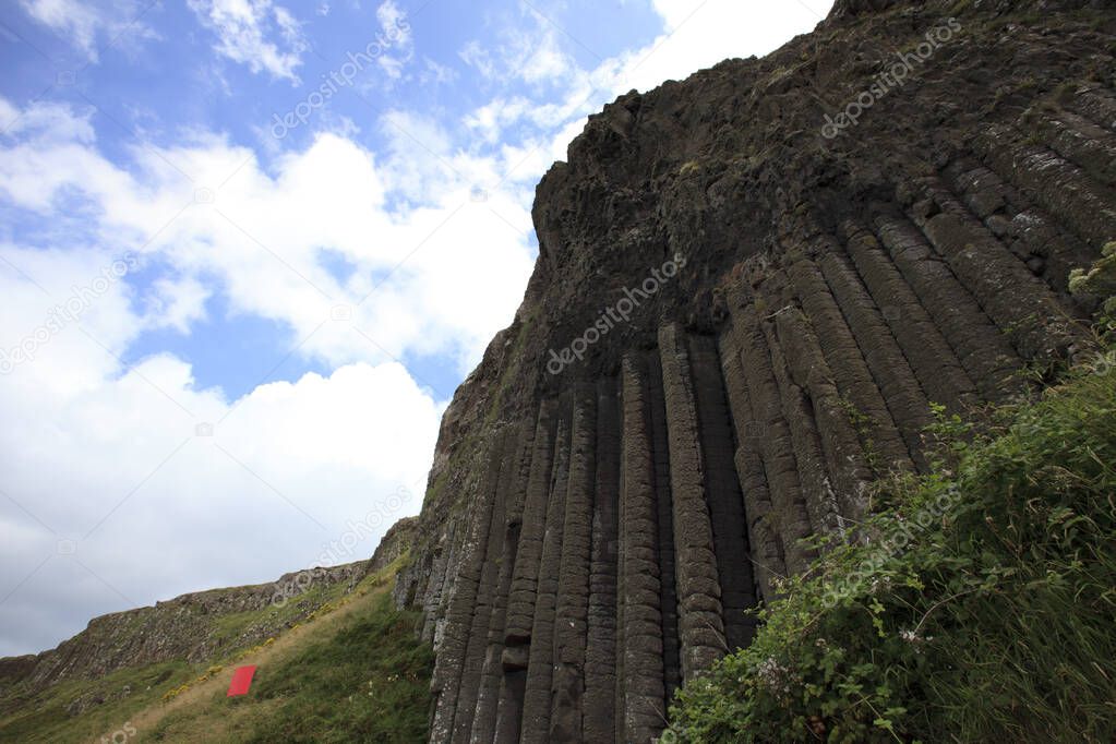 Ulster (Ireland), - July 20, 2016: Polygonal basalt lava rock columns of the Giant's Causeway on the north coast of County Antrim, Northern Ireland, UK