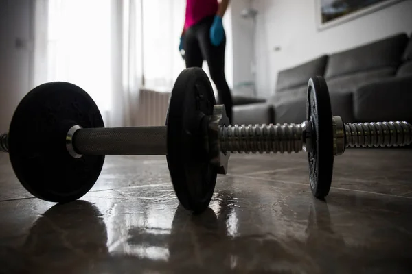 Girl doing sports with dumbbells at home