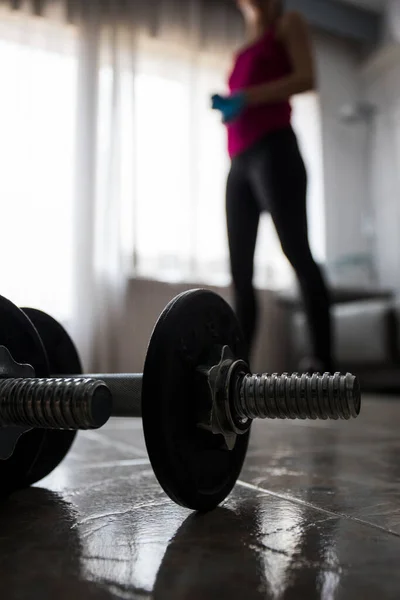 Girl doing sports with dumbbells at home