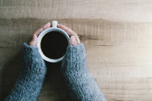 Woman Hands Gray Sweater Holding Cup Black Coffee Wooden Table — Stock Photo, Image