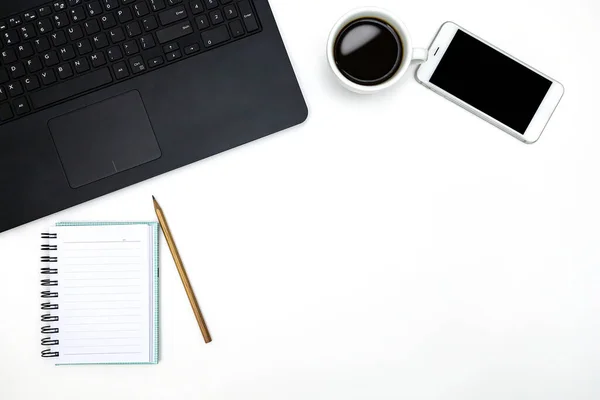 Office desktop with accessories and white coffee cup on white table. Top view. Business background.