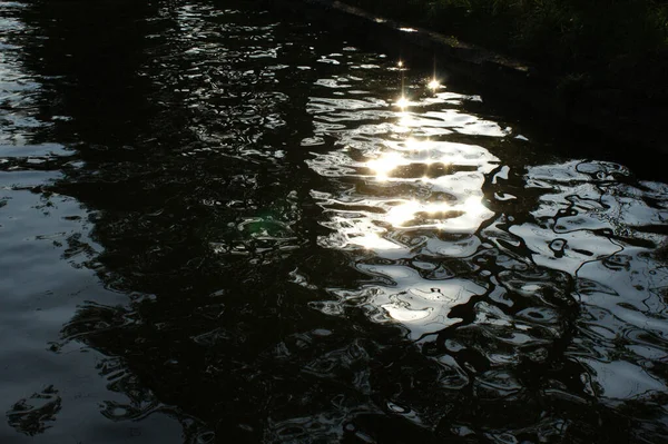 reflection of the sun in the water rippling water