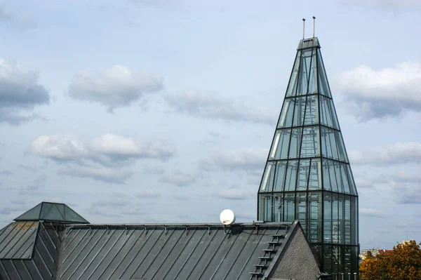 Gray modern church building. Transparent glass tower. Blue sky