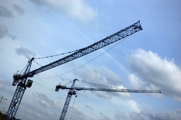 crane construction couple construction on the background of sky and clouds