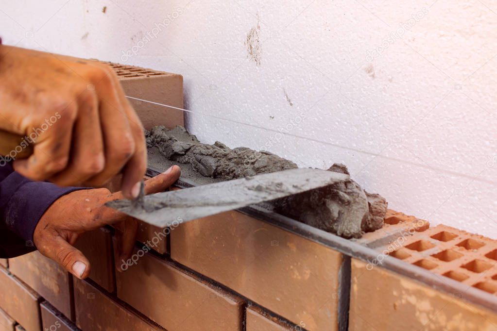Bricklayer lays the mortar for laying brick. construction work