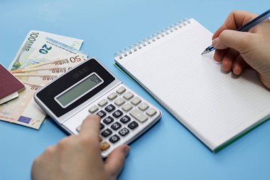 Hesap makinesi, para, mavi arka plan üstünde not etmek