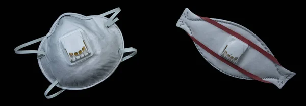 Two medical masks with a valve close up on a black background