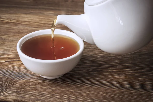 Closup Teapot Pouring Tea White Bowl Antique Wooden Table — Stock Photo, Image