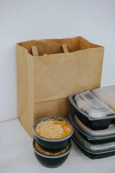 Food delivery. Black food containers, juice bottle