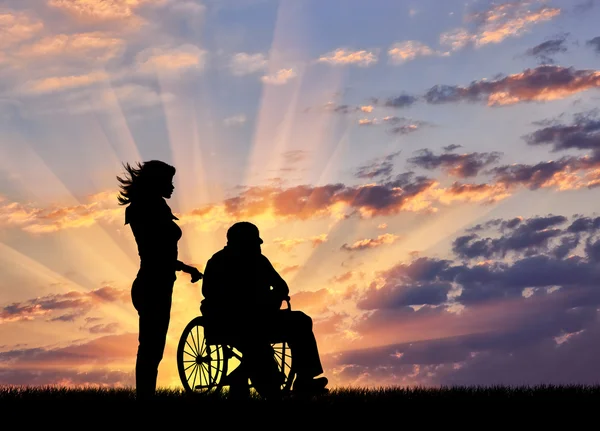 간호사가 휠체어에서 장애인에 대 한 배려의 실루엣 — 스톡 사진