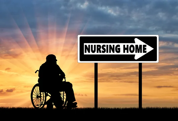 Silhouette of an elderly man in a wheelchair — Stock Photo, Image