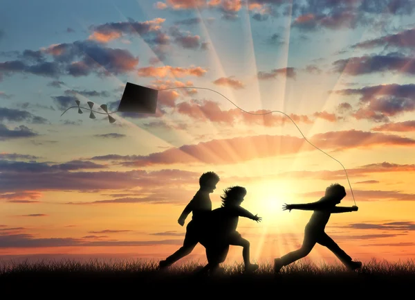 Children sunset play with kite — Stock Photo, Image