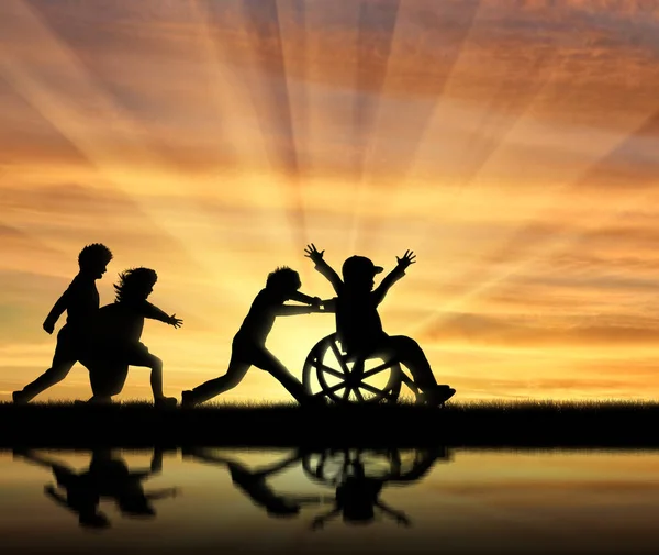 Happy boy in wheelchair playing with children and their reflection in water — Stock Photo, Image