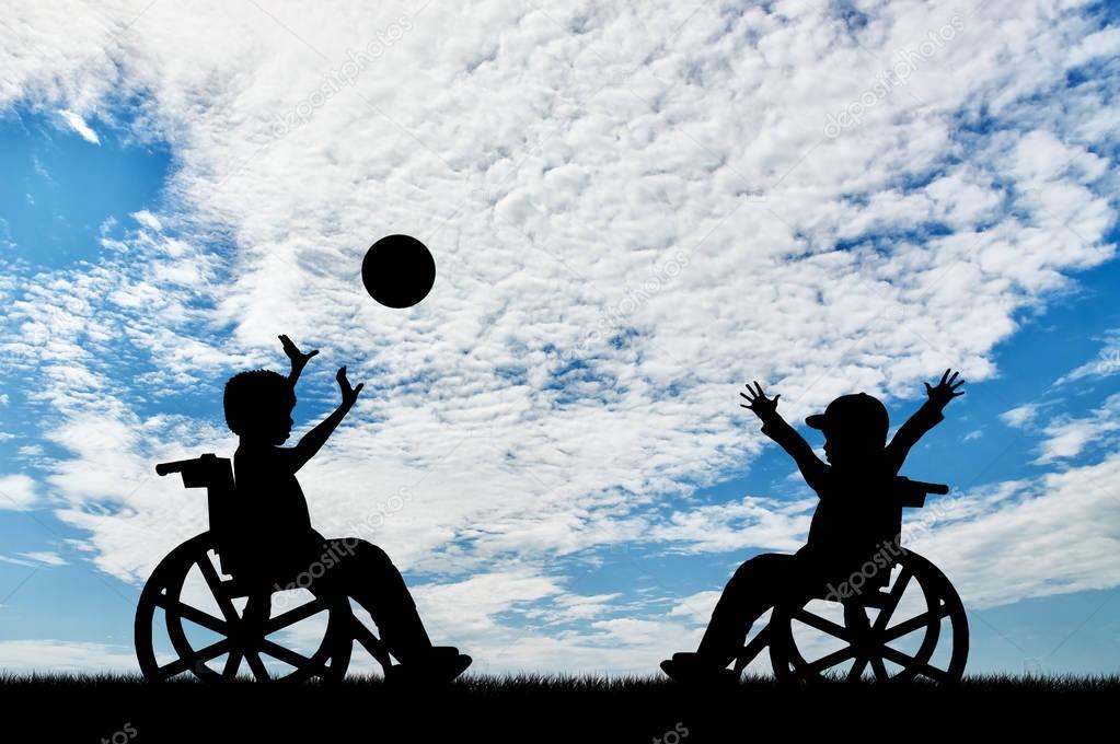 Happy children disabilities in wheelchair play ball day