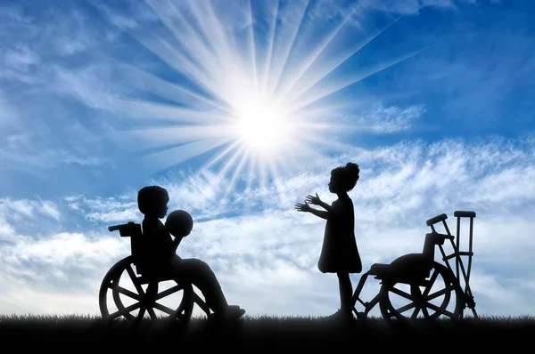 Girl playing with boy in wheelchair with ball — Stock Photo, Image