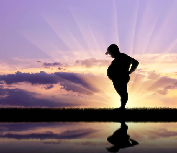 Fat kid and reflection on background sunset — Stock Photo, Image