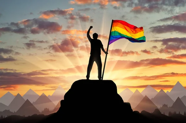 Silhouette with the gay rainbow flag — Stock Photo, Image