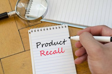 Human hand over wooden background and product recall text concep clipart