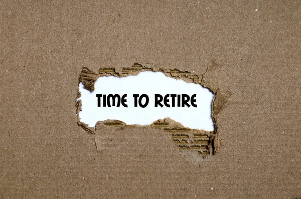 The word time to retire appearing behind torn paper — Stock Photo, Image