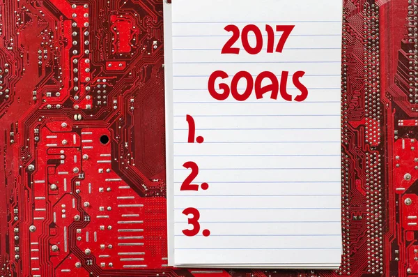 Red old dirty computer circuit board and 2017 goals text concept