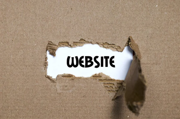 The word website appearing behind torn paper — Stock Photo, Image
