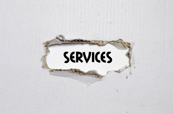 A szó szolgáltatások mögött megjelenő szakadt papírt — Stock Fotó