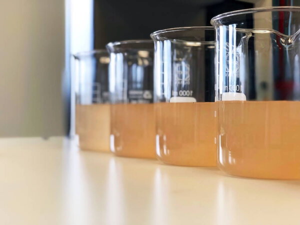 Waste water sample in beakers coagulation and flocculation method with Ferric chlorine and using Jar test for forming precipitation and reduced turbidity calibration range. Use for science background.