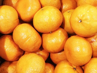 Portakal meyvesi, turuncu ve mandalina karışımı, turuncu renk dokusu veya arka plan arasında kalan turuncu türler, malzeme pişirmek için pazar raflarında satılıyor, restoran fotoğraf dekorasyonu konsepti. 