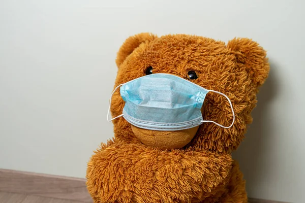 big teddy bear in a medical mask