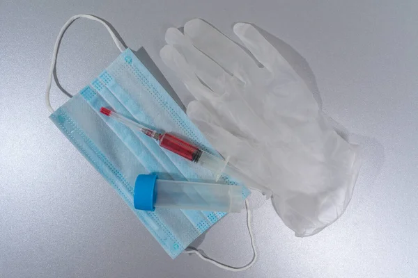 test tube, disposable glove, syringe with blood test, disposable mask. Blood Test Kit