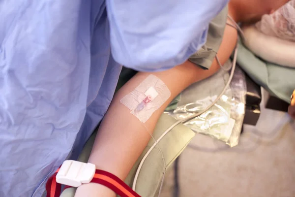 Hand of parient with iv drip on surgery on surgery