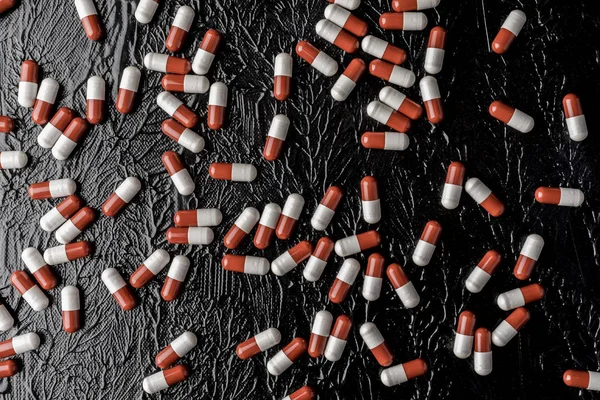 pills on the black bacground. Pills addiction concept