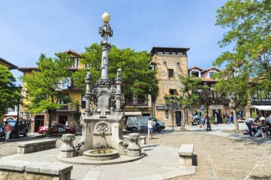 Fountain in the medieval village of Comillas in Spain clipart