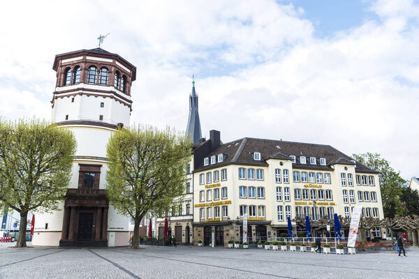 Dusseldorf, Germany - April 16, 2017: Burgplatz is a square next to the river Rhine with bar and people walking in Dusseldorf, Germany